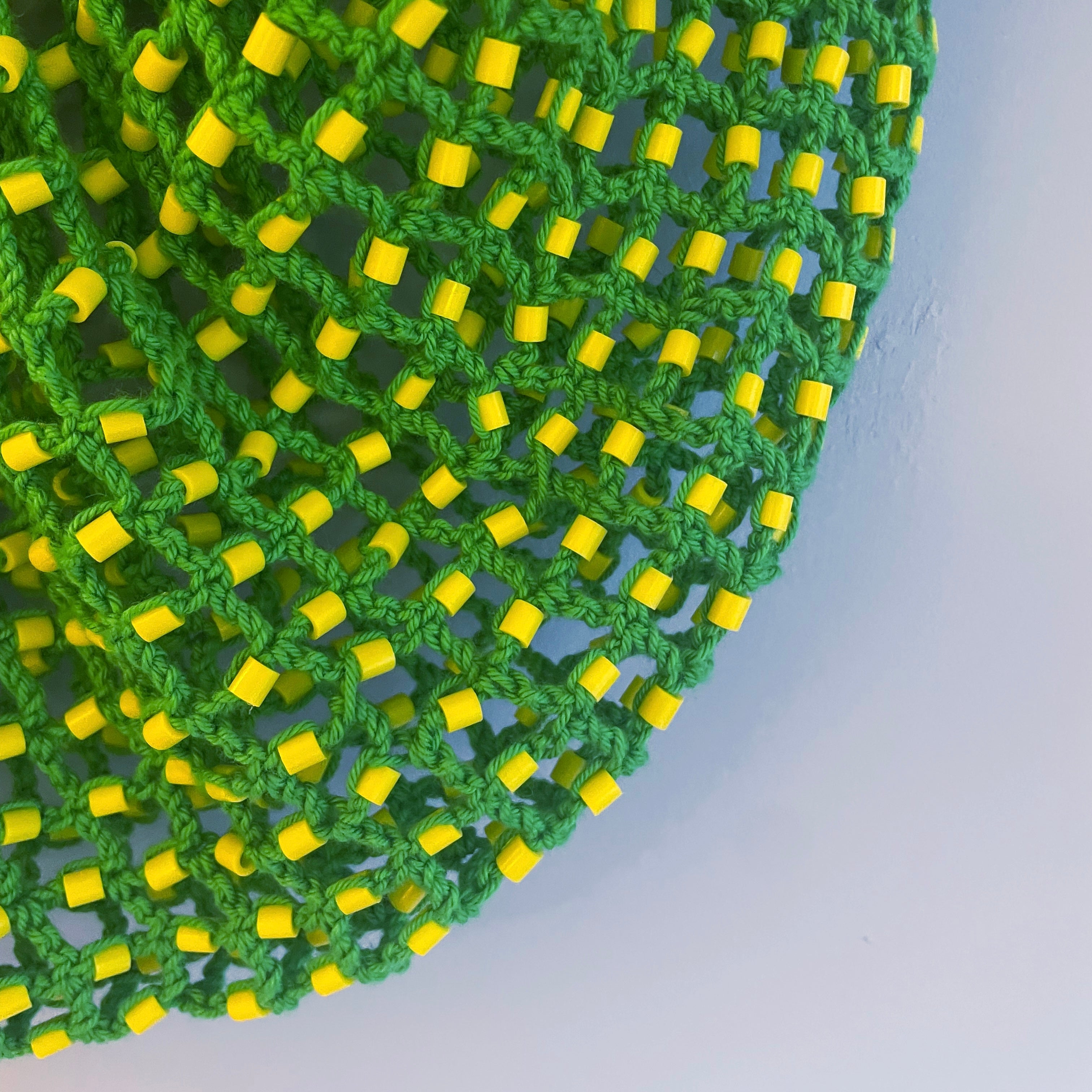 Green tote bag with yellow beads